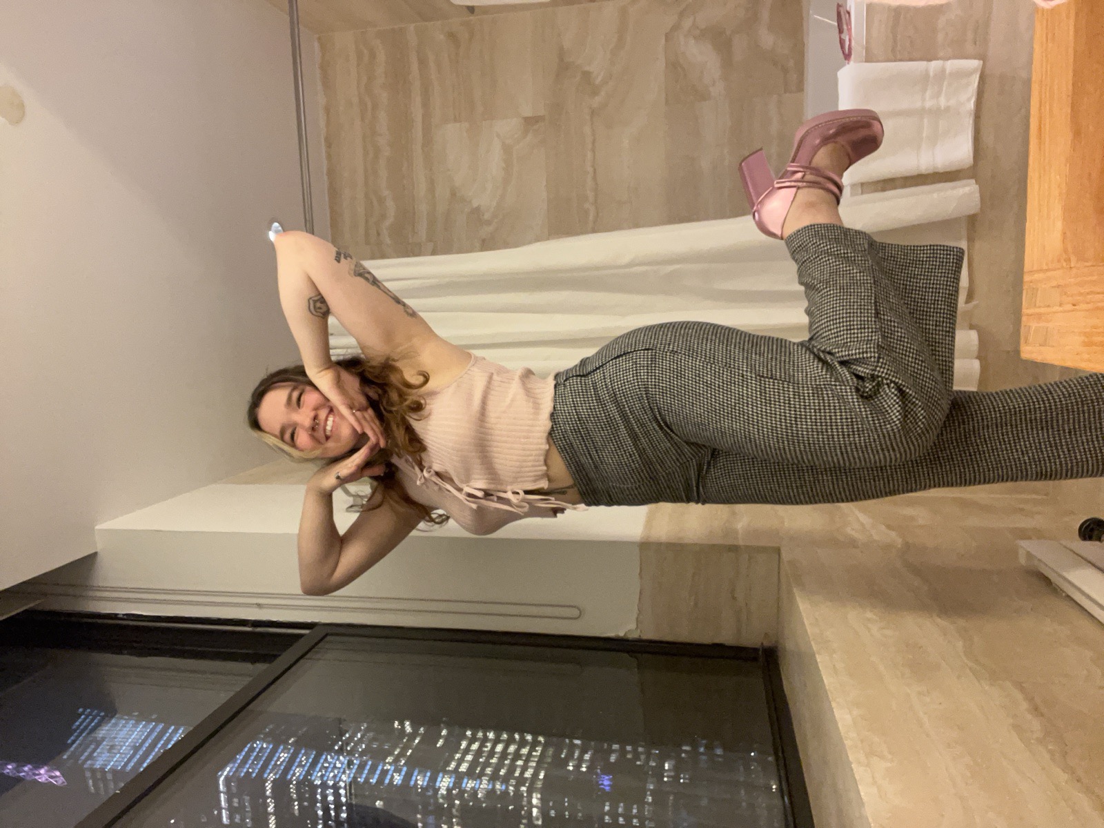 The maker striking a playful pose in metallic pink platform heels
