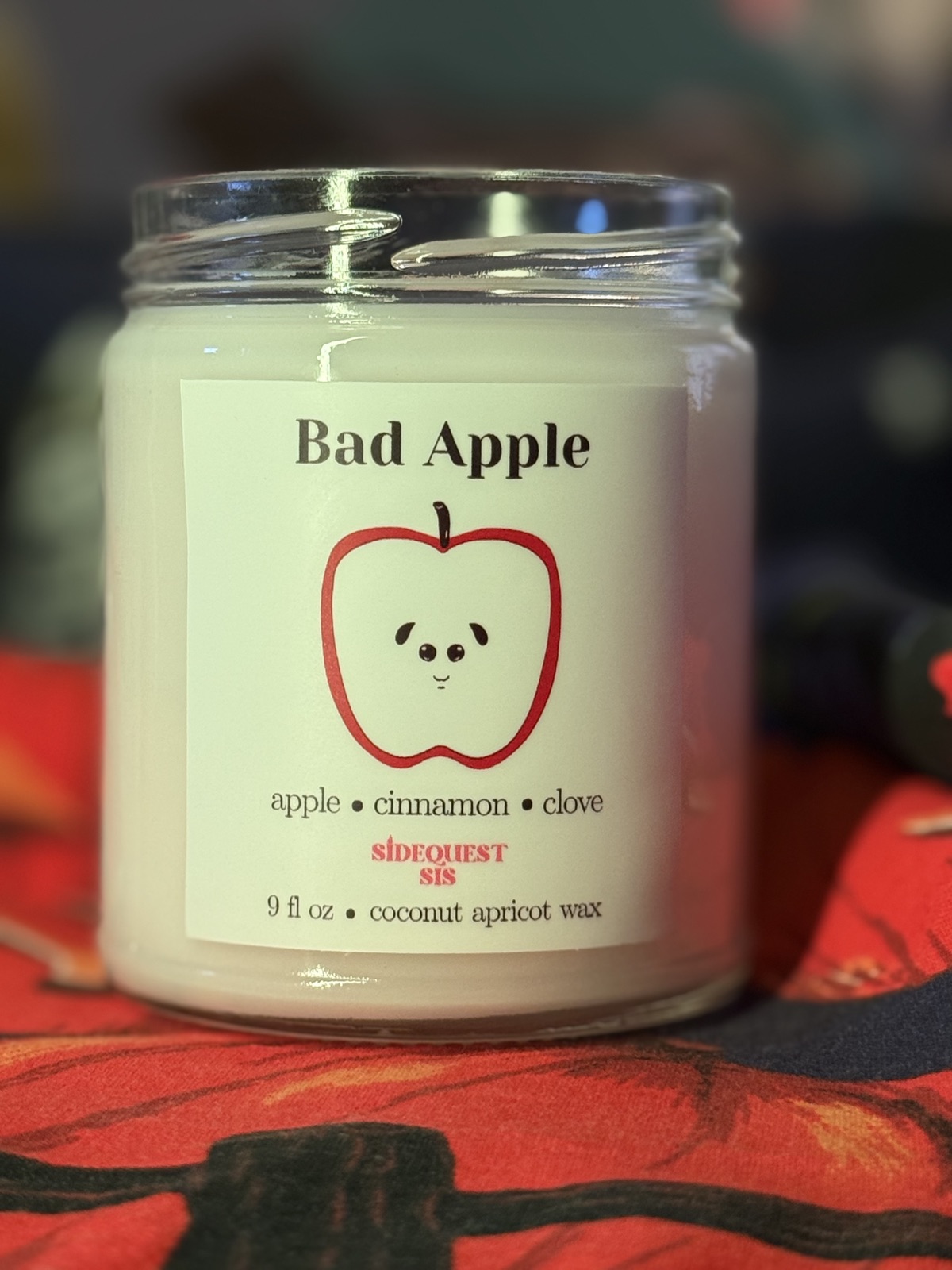 Trimming the wooden wick of a Sidequest Sis candle